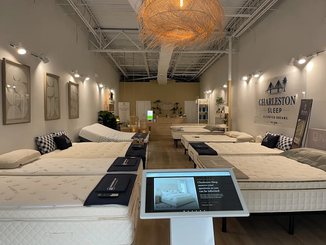 Inside the Charleston Sleep boutique showroom in West Ashley, with mattress displays and the Charleston Sleep wall sign