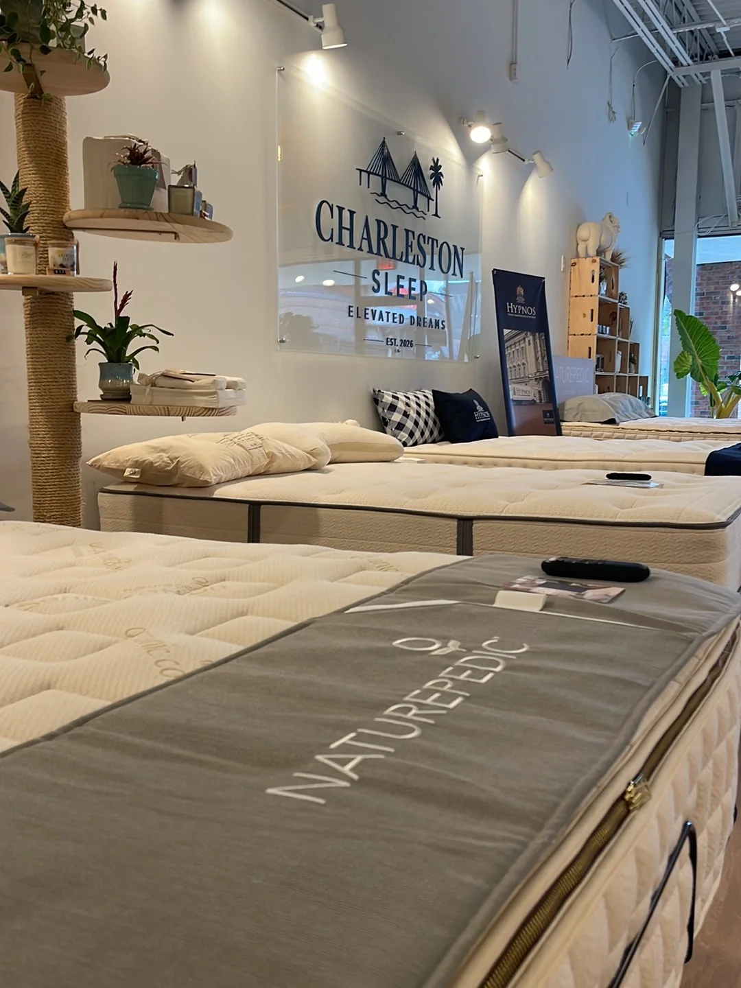 Naturepedic EOS Classic mattress displayed inside the Charleston Sleep showroom in West Ashley