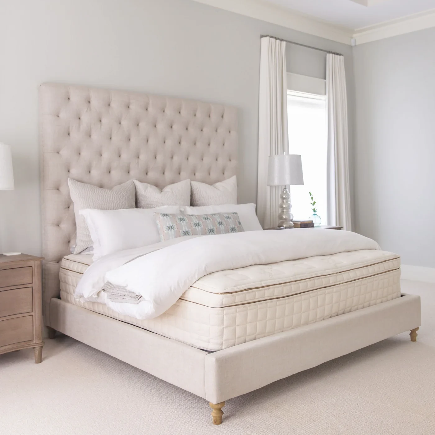 Naturepedic EOS PillowTop mattress shown in a softly lit bedroom